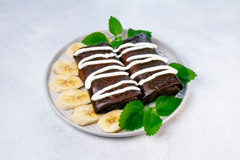 Chocolate crepes with cheese, banana, and nutella