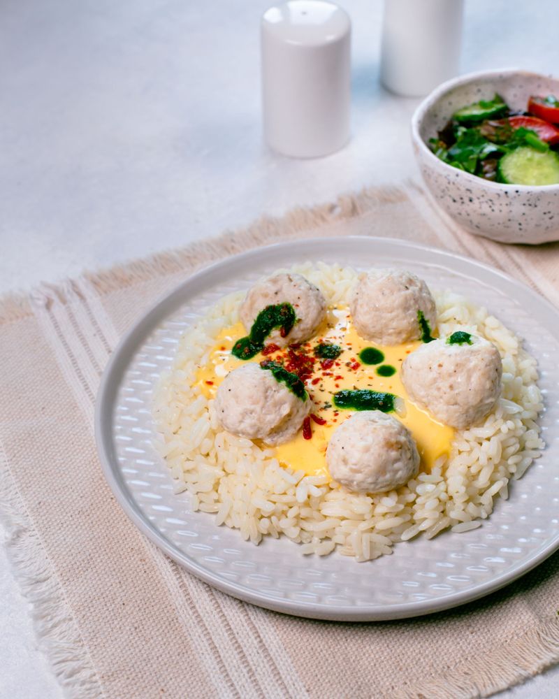 Chicken balls with rice and cheese sauce